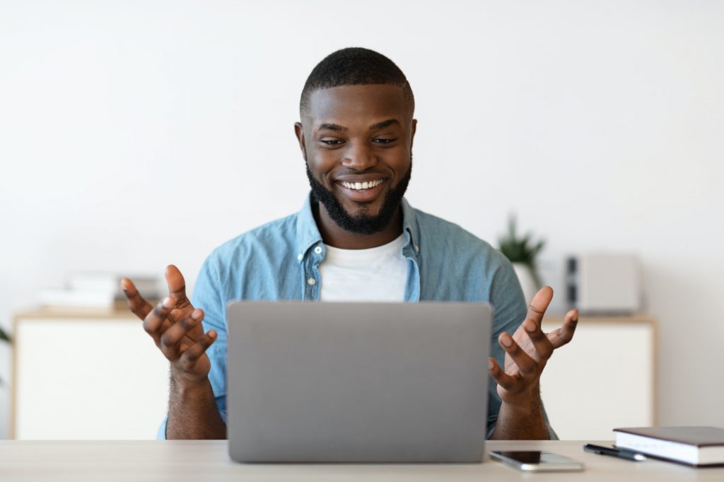 Web Conference. Cheerful Millennial African American Man Having Video Call On Laptop